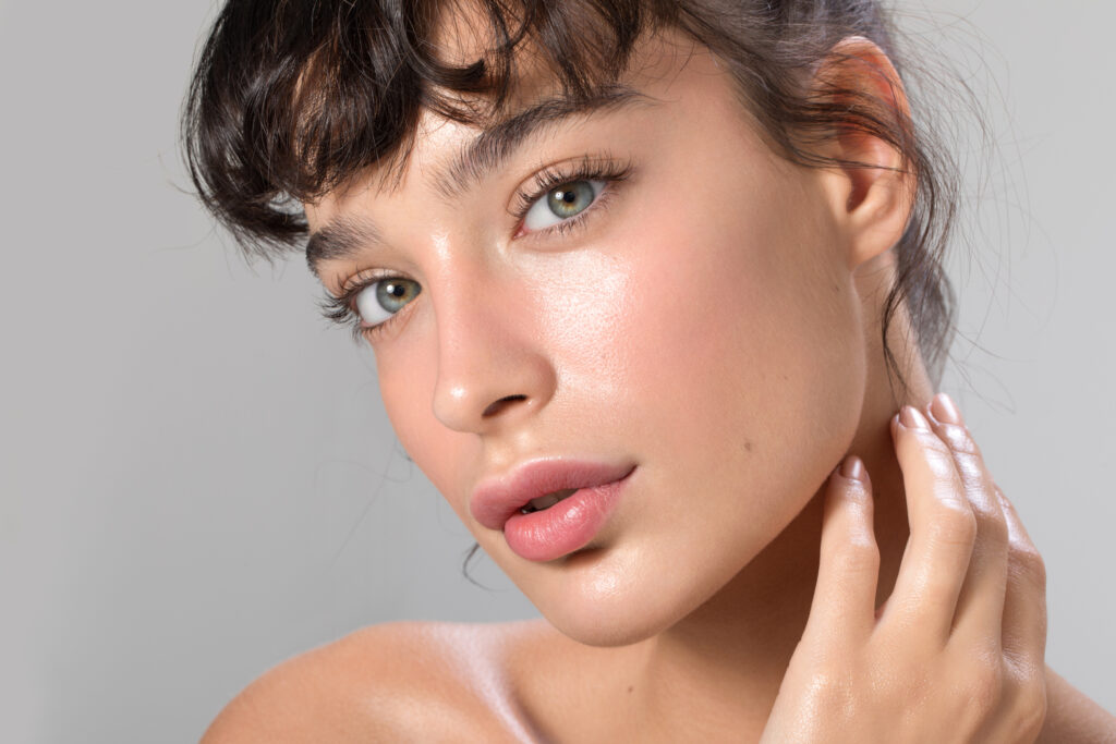 Woman with glowing skin after Exion® RF microneedling treatment.
